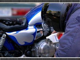 Rider Adding Oil to Motorcycle