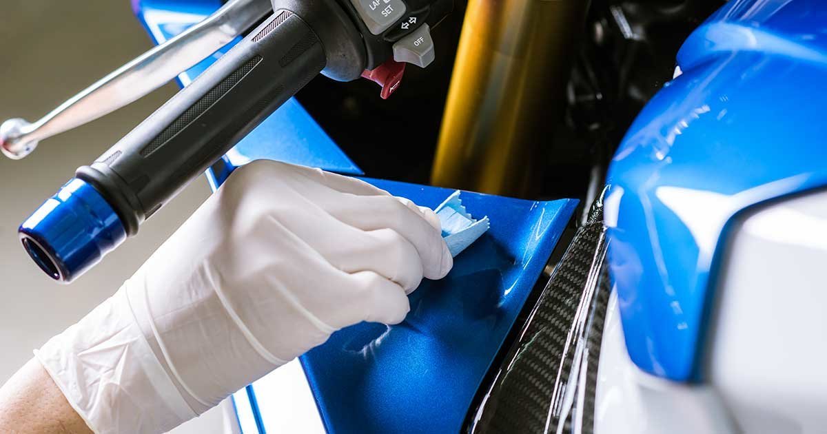 Polishing the paint finish on a motorcycle