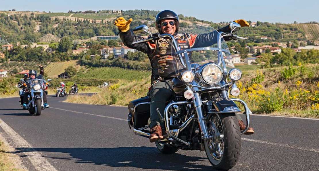 motorcycle rider on highway waving