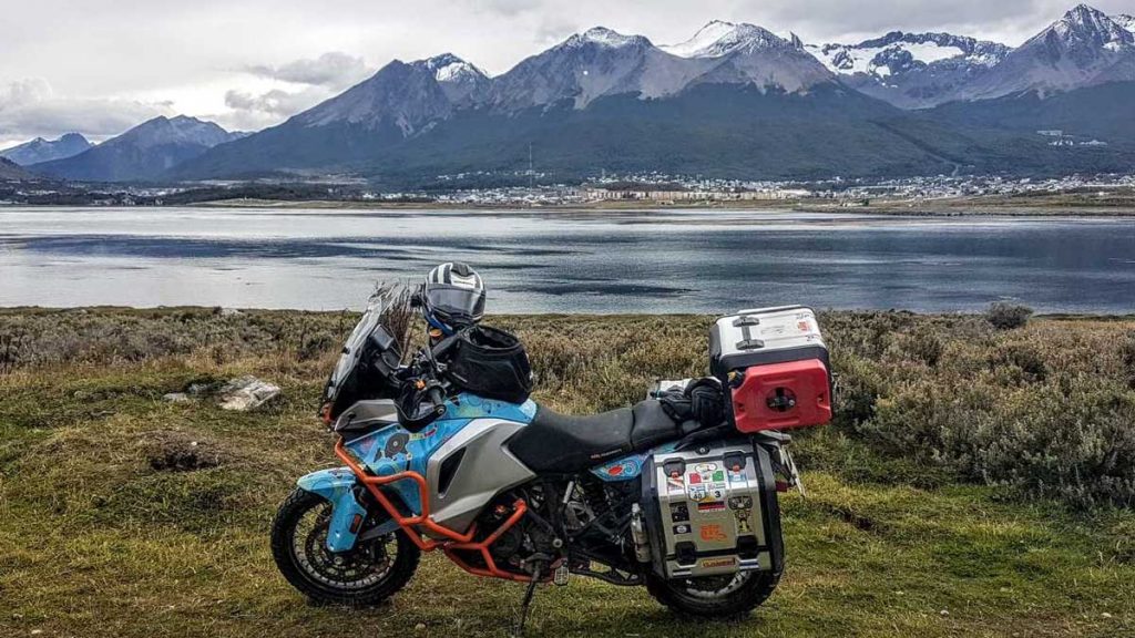 Motorcycle sitting next to a lake in Alaska