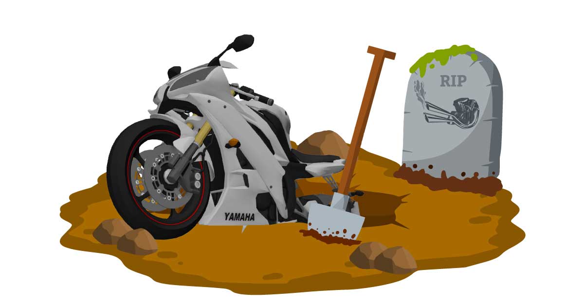 Motorcycle being buried in dirt next to tombstone