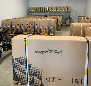 Warehouse stocked with electric motorcycles in boxes