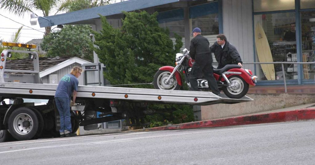 motorcycle loading on flatbed truck