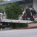 motorcycle loading on flatbed truck