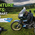 Motorcycle fully equipped with camping gear for a road trip adventure.